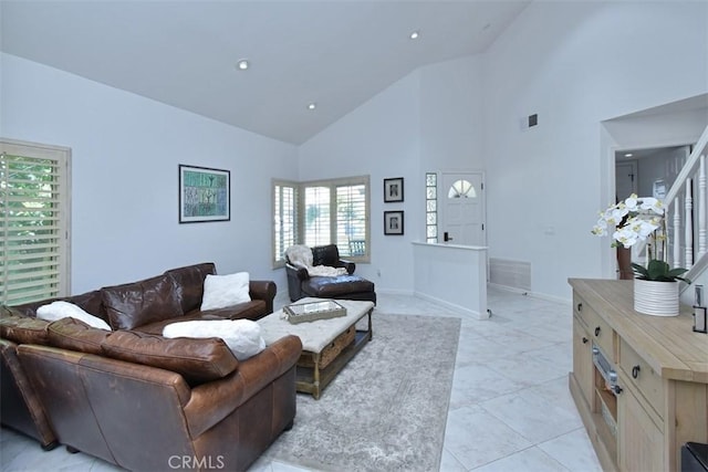 tiled living room with high vaulted ceiling