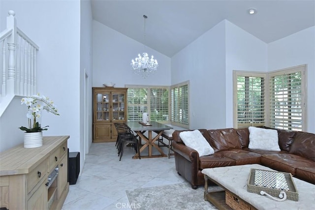 living room with light tile patterned floors, a chandelier, and high vaulted ceiling