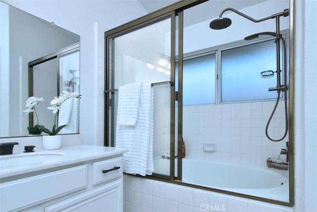 bathroom featuring vanity and bath / shower combo with glass door