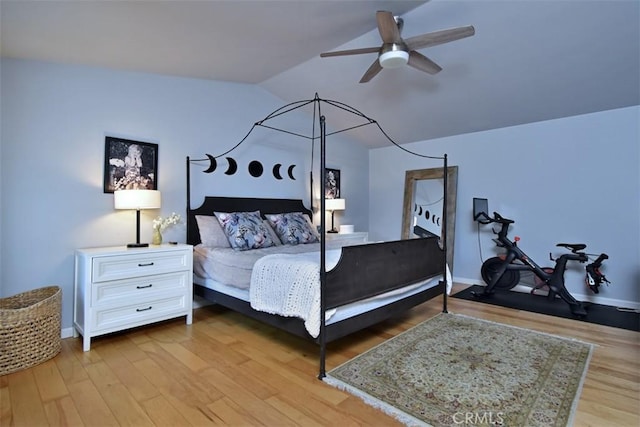 bedroom featuring ceiling fan, vaulted ceiling, and light wood-type flooring