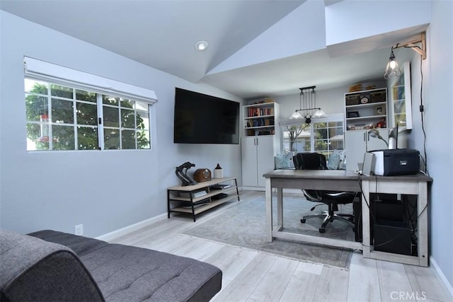 home office featuring light hardwood / wood-style floors and lofted ceiling