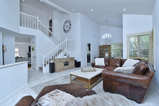 living room with high vaulted ceiling and a notable chandelier