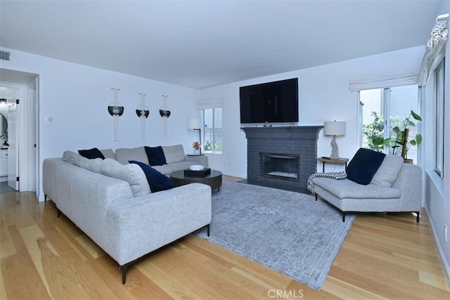 living room featuring a fireplace and hardwood / wood-style floors