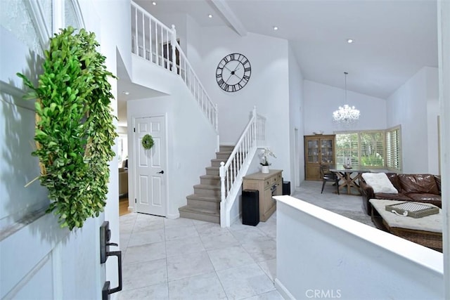 entryway featuring a notable chandelier, light tile patterned floors, beam ceiling, and high vaulted ceiling