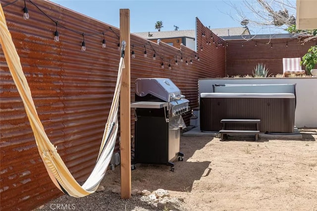 exterior space with area for grilling and a hot tub