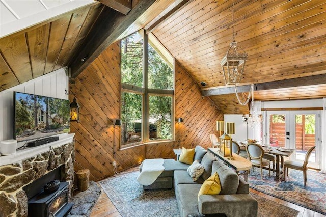 living room with hardwood / wood-style floors, beamed ceiling, and wooden walls