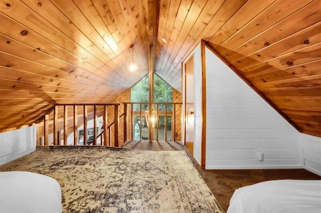 bonus room featuring lofted ceiling with beams, wood ceiling, wooden walls, and dark colored carpet