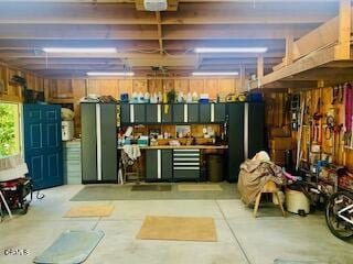 garage featuring a garage door opener and a workshop area