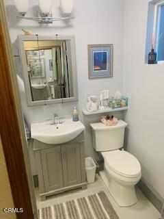 bathroom featuring vanity, tile patterned floors, and toilet