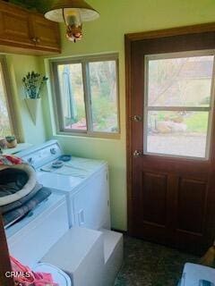 laundry area featuring independent washer and dryer, cabinets, and plenty of natural light