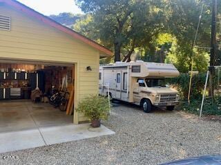 view of side of property featuring a garage and an outbuilding