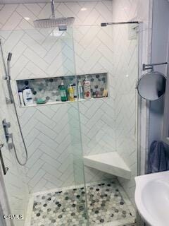 bathroom with a shower with shower door