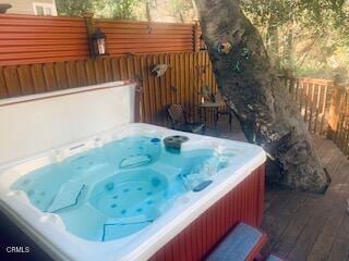 wooden terrace with a hot tub