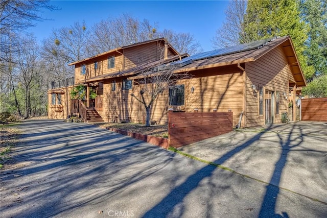 view of front of property featuring solar panels