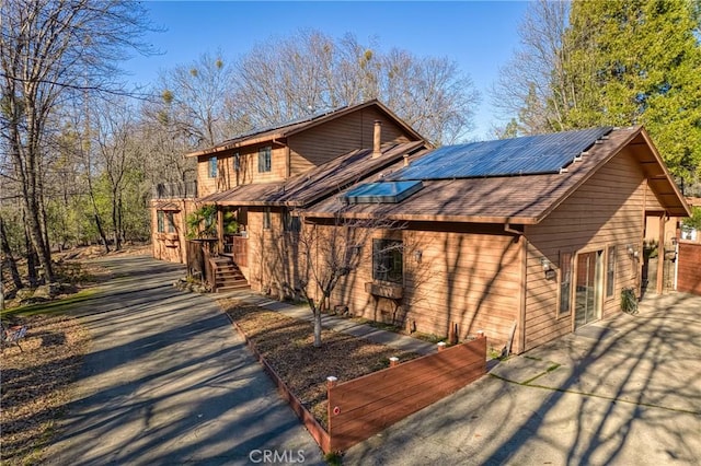 view of front facade with solar panels