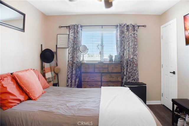 bedroom with dark hardwood / wood-style flooring