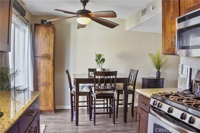 dining area featuring ceiling fan and light hardwood / wood-style flooring