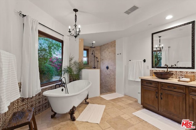 bathroom with vanity, shower with separate bathtub, tile walls, and an inviting chandelier