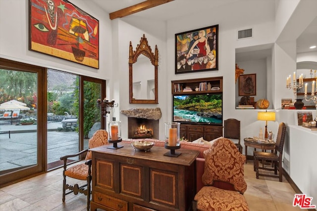 sitting room featuring a notable chandelier and beamed ceiling