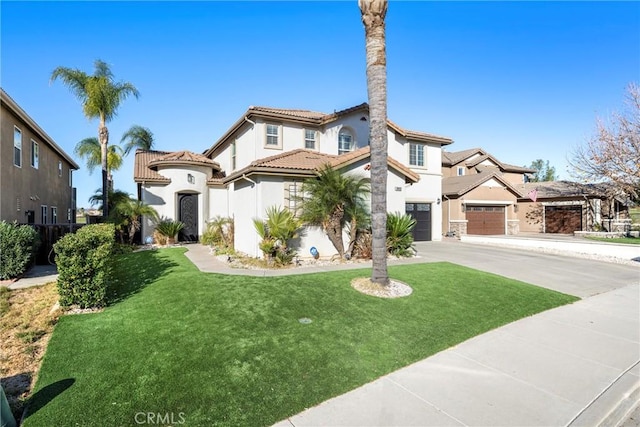 mediterranean / spanish-style home with a garage and a front lawn