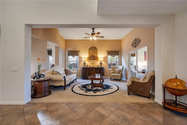 sitting room featuring ceiling fan and tile patterned floors