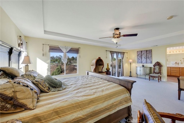 bedroom featuring ceiling fan, ensuite bath, and carpet floors