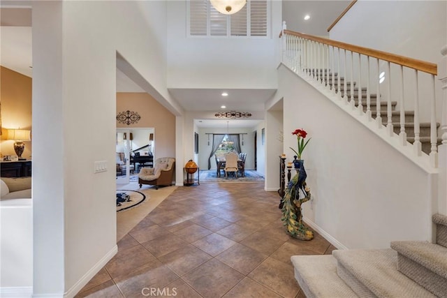 foyer entrance with a towering ceiling and tile patterned flooring