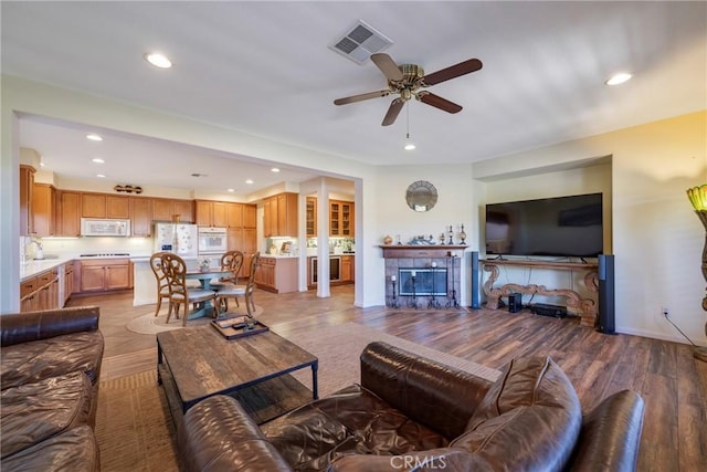 living room featuring ceiling fan and light wood-type flooring