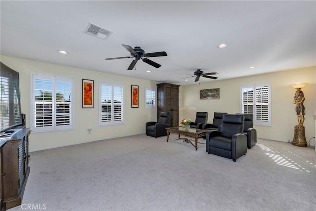 carpeted living room featuring ceiling fan