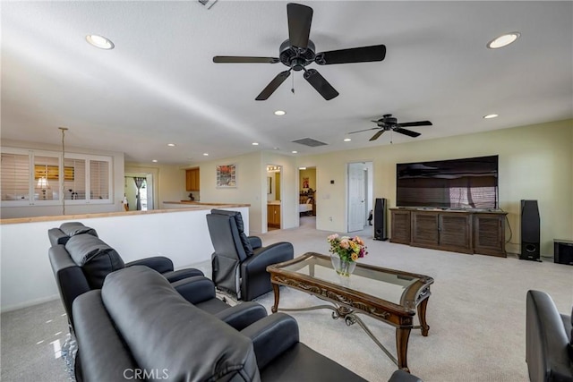 carpeted living room with ceiling fan