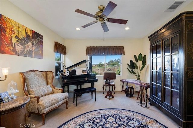 living area featuring ceiling fan and carpet floors