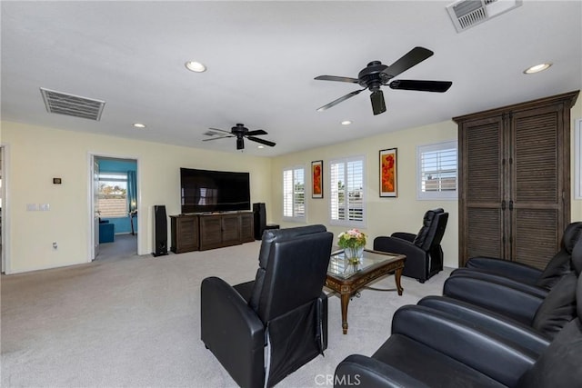 carpeted living room featuring ceiling fan