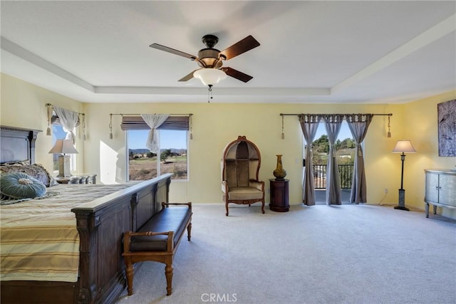 bedroom featuring ceiling fan, access to exterior, carpet, and multiple windows