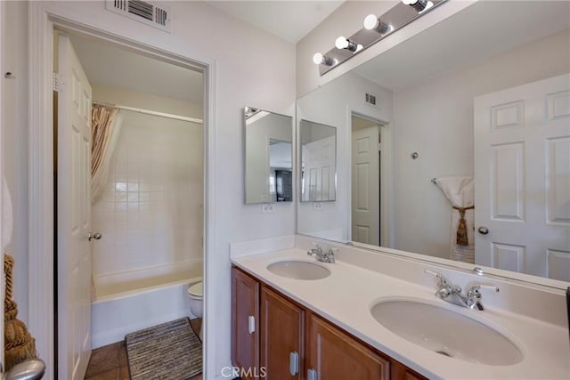 full bathroom featuring toilet, vanity, tile patterned flooring, and shower / bath combo with shower curtain