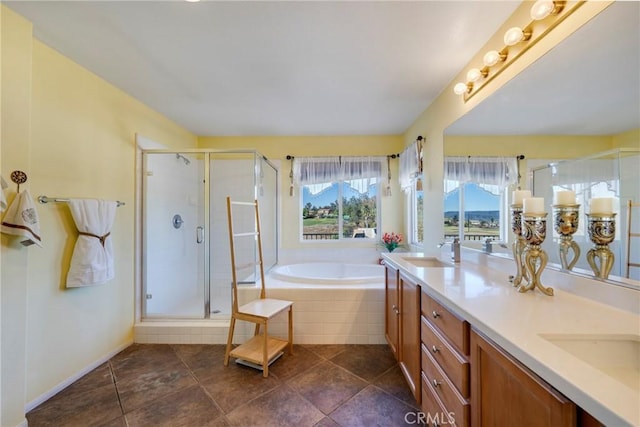 bathroom with tile patterned flooring, separate shower and tub, and vanity