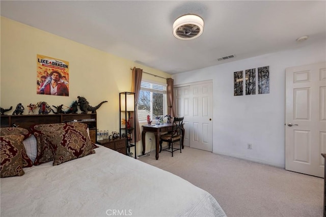 bedroom with a closet and light carpet