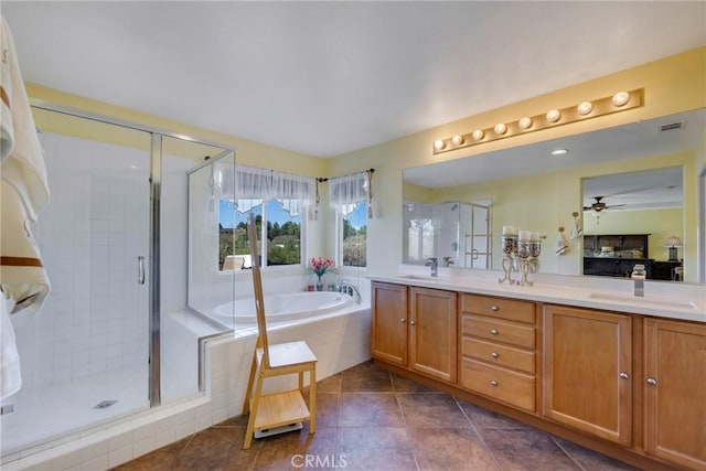 bathroom featuring ceiling fan, tile patterned flooring, vanity, and shower with separate bathtub