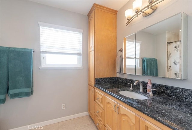 bathroom featuring vanity, tile patterned flooring, and plenty of natural light