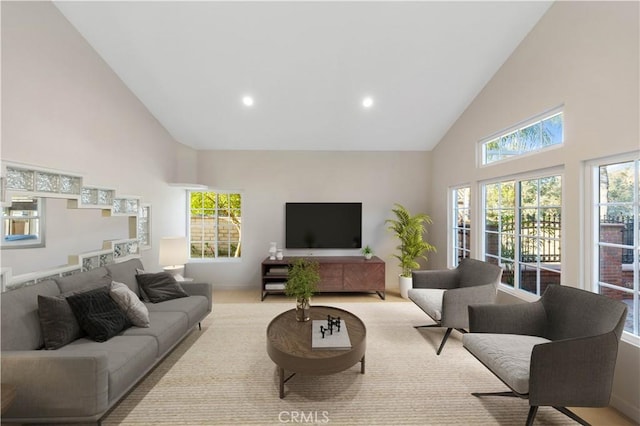 living room featuring high vaulted ceiling and light carpet