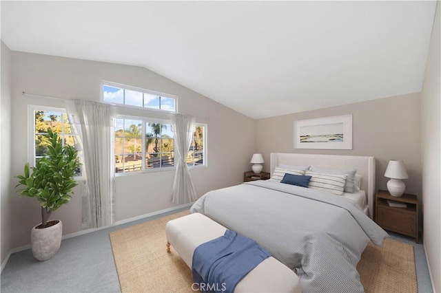 bedroom featuring vaulted ceiling and carpet flooring