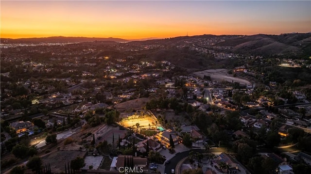 aerial view at dusk featuring a mountain view