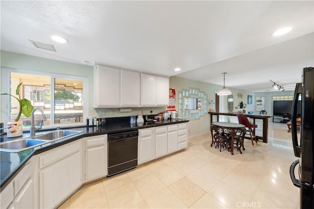 kitchen with white cabinetry, sink, hanging light fixtures, and black appliances