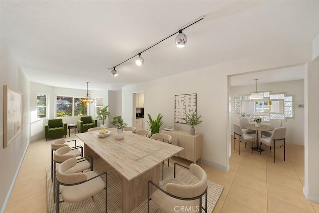 dining area with light tile patterned floors and a notable chandelier