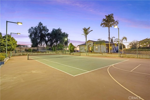 view of tennis court with basketball hoop