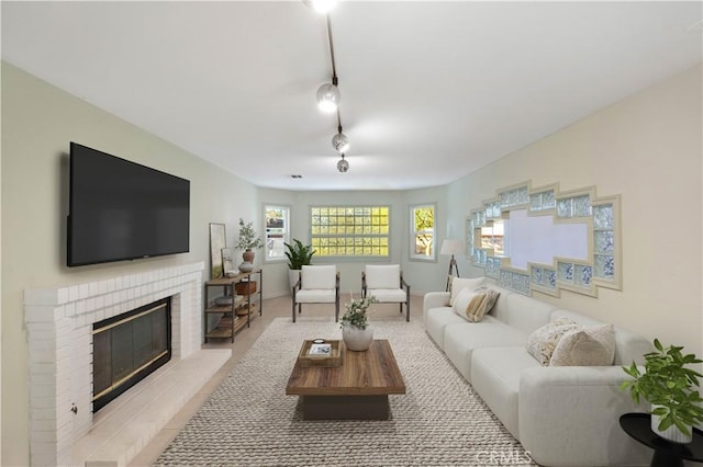 living room with a brick fireplace