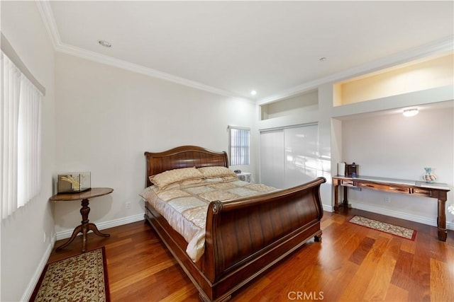 bedroom featuring wood-type flooring, a closet, and crown molding