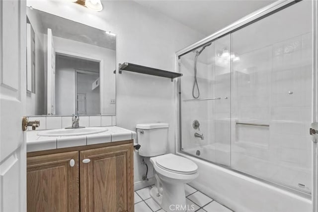 full bathroom featuring toilet, combined bath / shower with glass door, tile patterned floors, and vanity