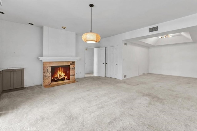 unfurnished living room featuring carpet and a fireplace