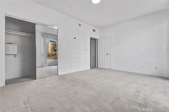 unfurnished bedroom featuring a closet and carpet flooring