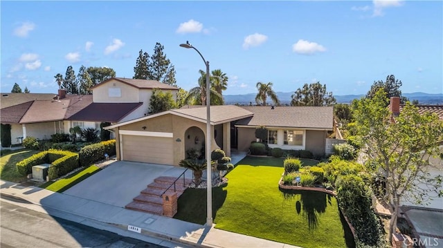 single story home with a front yard and a garage